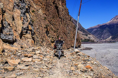motorbike on rocky road - annapurnas (nepal), 350cc, annapurnas, cliff, dirt road, kali gandaki valley, motorcycle touring, mountain road, rider, riding, rocks, royal enfield bullet, thunderbird, unpaved