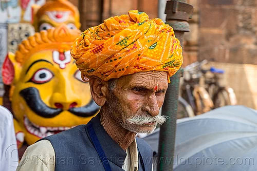 mustachioed hindu pilgrim at the lingaraja temple - bhubaneswar (india), bhubaneswar, headwear, hindu man, hindu temple, hinduism, indian man, lingaraj temple, lingaraja temple, mustache, painted, pilgrim, sculpture, stone tiger, tilak, tilaka, turban, yellow