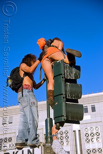 people climbing on traffic lights - lovefest (san francisco), climbing, guy, lovevolution, man, traffic light, woman
