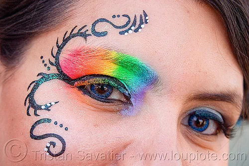 rainbow eye makeup, blue contact lenses, blue contacts, color contact lenses, colored lenses, eye makup, face painting, facepaint, gay pride festival, rainbow colors, rainbow makeup, woman