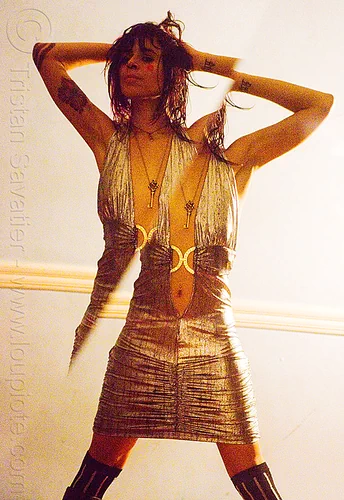 reflection in a broken mirror, arm tattoos, broken image, broken mirror, diagonal, key necklace, silver dress, woman