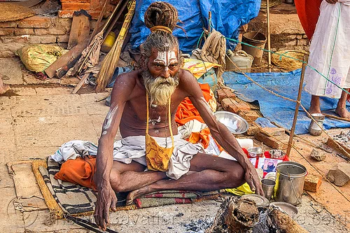 sadhu sitting cross-legged with threatening eyes (nepal), baba, beard, bonfire, cross-legged, dreadlocks, hindu, hinduism, kathmandu, knotted hair, maha shivaratri, man, pashupatinath, sadhu, sitting, tilak, tilaka