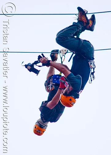 shooting a youtube video on the zip-line over san francisco, adventure, blue sky, cable line, cables, camcorder, camera, climbing helmet, embarcadero, hanging, jay, men, mountaineering, moving fast, shooting, speed, steel cable, trolley, tyrolienne, upside-down, urban, video, youtube, zip line, zip wire
