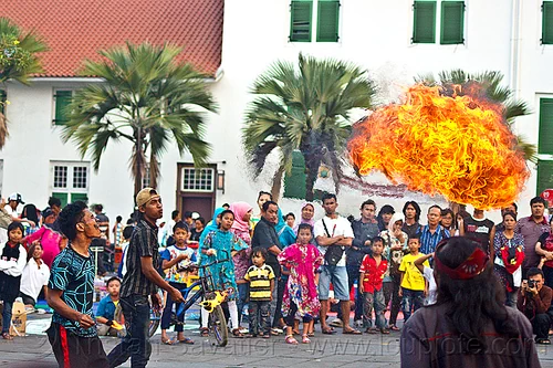street circus performers breathing fire (jakarta), crowd, eid ul-fitr, fatahillah square, fire breather, fire breathing, fire performer, jakarta, palm trees, spectators, spitting fire, street performers, taman fatahillah