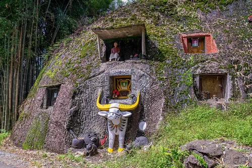 toraja rock-tombs with tau-tau effigy and carved water buffalo, burial site, cemetery, effigies, grave, graveyard, liang pak, pa'tedong, rock tombs, tana toraja, tau-tau, tomb