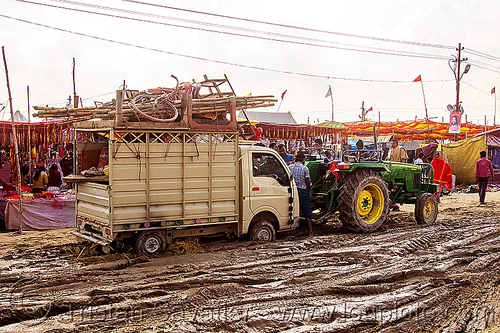 tractor pulling small truck stuck in mud (india), car, farm tractor, hindu pilgrimage, hinduism, kumbh mela, lorry, mud ruts, muddy road, muddy street, towed, towing, truck