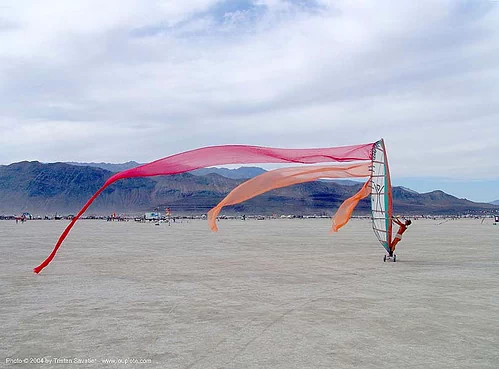 windsurfing on the playa - burning man 2004 - landsailing, dust storm, landsailing, streamer flags, streamers, street sailing, windsurfing