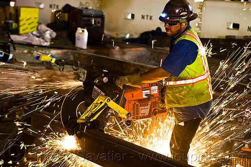 worker cutting rail with handheld abrasive saw, 3120x, abrasive saw, cut-off saw, cutting, headlamp, headlight, high-visibility jacket, high-visibility vest, huskvama, light rail, man, muni, night, ntk, power tool, railroad construction, railroad tracks, railway tracks, reflective jacket, reflective vest, safety glasses, safety gloves, safety helmet, safety vest, san francisco municipal railway, sparks, track maintenance, track work, worker, working