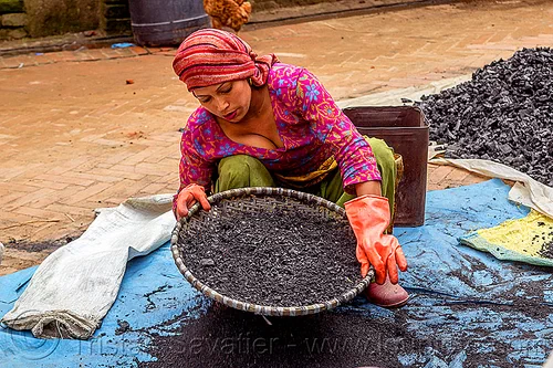young nepali woman sifting charcoal (nepal), bhaktapur, blue, charcoal, coal, gloves, heap, sift, sifting, squatting, tarp, woman