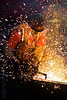 oxy-acetylene cutting torch, dust mask, high-visibility jacket, high-visibility vest, light rail, man, muni, night, ntk, oxy-acetylene cutting torch, oxy-fuel cutting, railroad construction, railroad tracks, railway tracks, reflective jacket, reflective vest, safety helmet, safety vest, san francisco municipal railway, sparks, track maintenance, track work, welder, worker, working